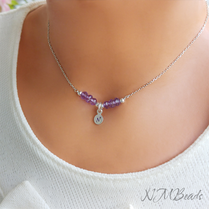An Amethyst necklace with letter disc