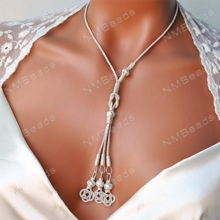 Hand braided chain necklace have a long tassel with 3 love knot motif.